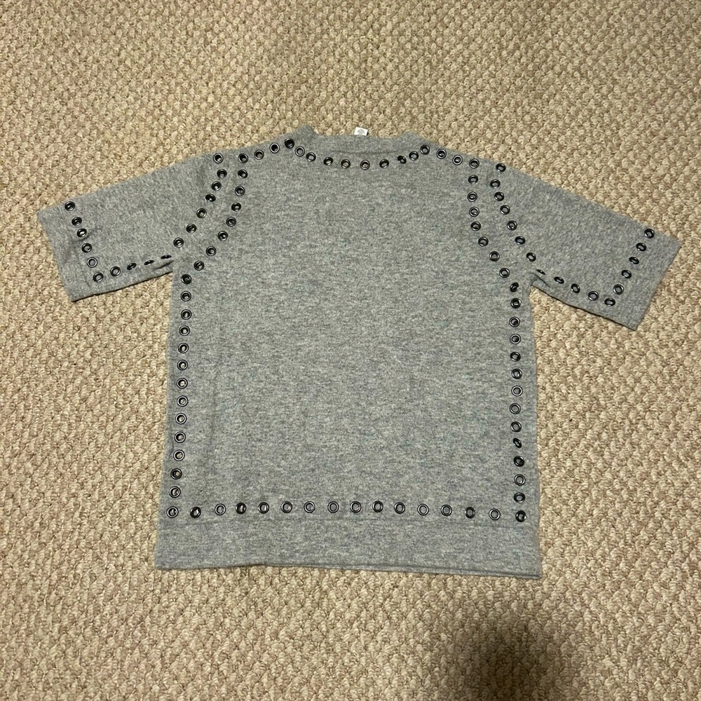 Heather gray 3/4 sleeve cashmere sweater with grommet detail.